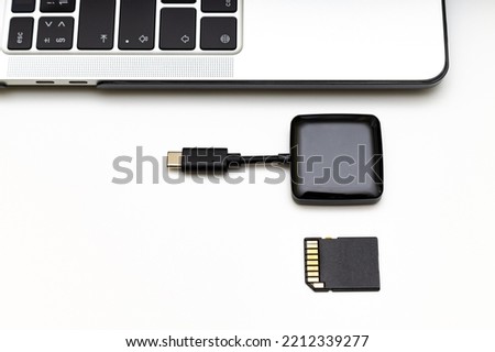 memory card and card reader connected to laptop. High quality photo