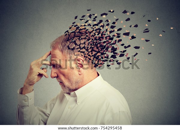 Memory loss due to dementia.
Senior man losing parts of head  as symbol of decreased mind
function.