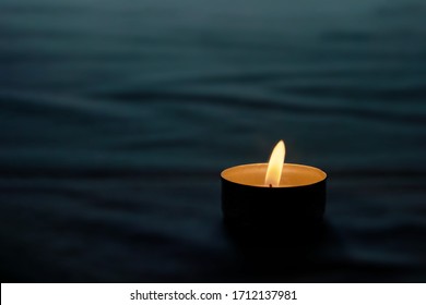 In Memory Of The Victims, A Candle Is Lit On A Black Background.Memorial Day