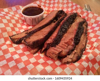 Memphis Style Smoked Brisket With A Side Of BBQ Sauce