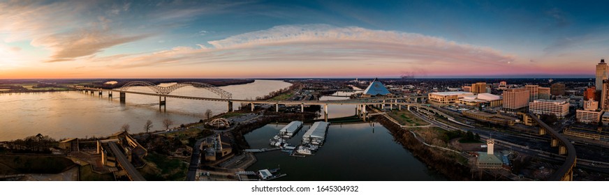 Memphis, Tennessee / USA - February 8, 2020: Panorama of downtown Memphis, TN, pyramid, and Hernando Desoto Bridge. Cityscape with skyscrapers, striking contrast, vibrant colors, modern art photograph