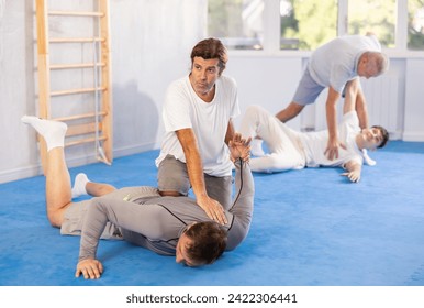 Men athletes practice Brazilian jiu Jitsu Aikido Wing chun wrestling. Training at Academy of Martial Arts martial arts hand-to-hand combat. - Powered by Shutterstock