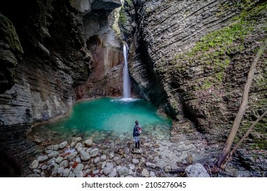 Men, backpacker standing in front of waterfall Kozjak in Triglav National Park, Slovenia