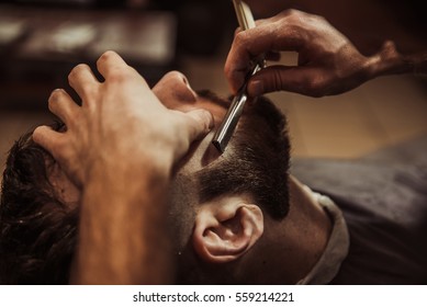 Men Barber Shaves His Beard.