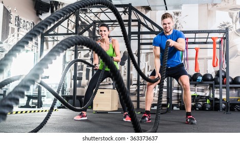 Men with battle rope in functional training fitness gym - Shutterstock ID 363373637