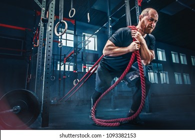 Men With Battle Rope Battle Ropes Exercise In The Fitness Gym. CrossFit Concept.