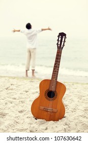 Men At The Beach And Guitar.