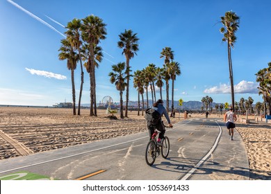 Men Biking And Running On Santa Monica Bike Path