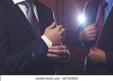 men in black suit with hand