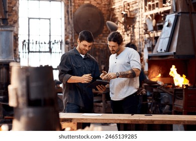 Men, blacksmith and tablet in workshop on teamwork for research and collaboration. Small business, craft and metal with browsing internet for steel ideas, engineer and manufacturing as welder - Powered by Shutterstock