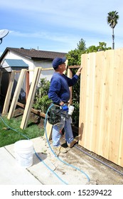 Men Building A Fence In Garden