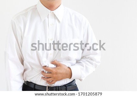 Men in business shirt suffering from holding their stomach Stock photo © 