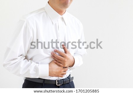 Men in business shirt suffering from holding their stomach Stock photo © 