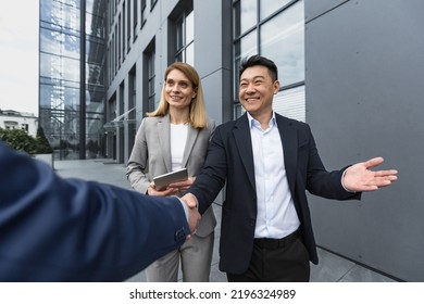 Men In Business Suits Greet And Shake Hands, Team Of Diverse Business People Meet Outside Office Building