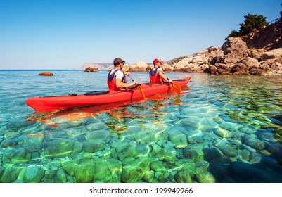 Men by sea kayaking. Traveling by kayak. Leisure activities on the water. - Shutterstock ID 199949966