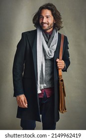 Men Can Dress Up Too. Shot Of A Stylishly Dressed Man Posing With A Leather Satchel In The Studio.