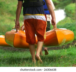 Men Carrying Kayaks