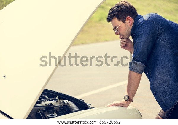 Men\
Checking Broke Down Car on Street Side with Open\
Hood