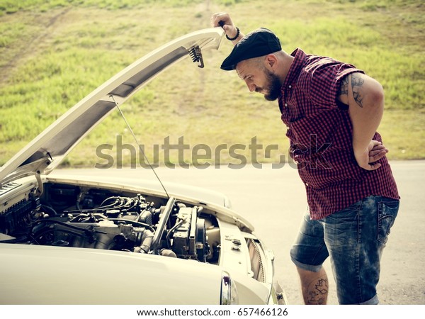 Men\
Checking Broke Down Car on Street Side with Open\
Hood