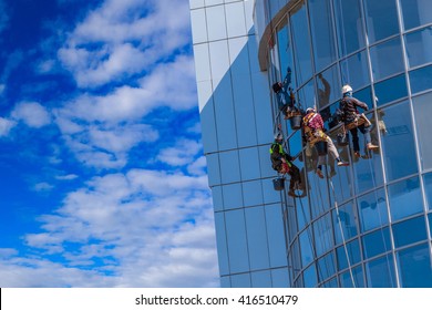 Men Cleaning Glass Building. High-rise, Industrial Mountaineering