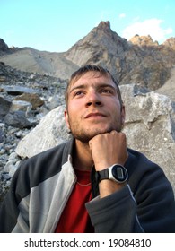 Men climber thinks about mountains.
