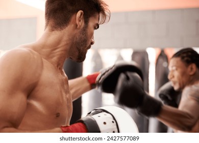 Men, coach and mixed martial arts with training fight, gloves and punch pad for fitness in gym. People, combat and action for mma, boxing or hands for power, workout and exercise for competition