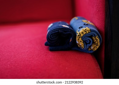 Men colorful socks. rolled-up socks on a red sofa.