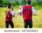 Men dancing dressed in traditional clothing. Annual Rose picking ritual in Bulgaria
