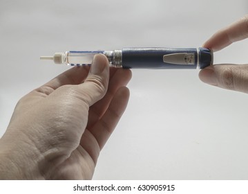 men diabetes patient using insulin injection pen on white background - Shutterstock ID 630905915