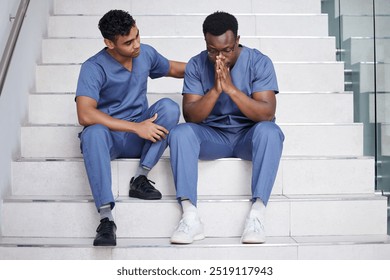 Men, doctors and comfort with stress at hospital for medical mistake, depression and healthcare burnout. People, consoling and stairs with surgery news, mental health anxiety and emergency crisis - Powered by Shutterstock