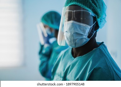 Men doctors at work inside hospital during coronavirus outbreak - Medical worker on Covid-19 crisis wearing face protective mask - Focus on mask - Shutterstock ID 1897905148