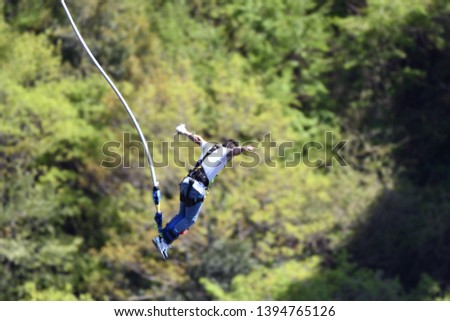Men doing bungee jumping from the top of the bridge