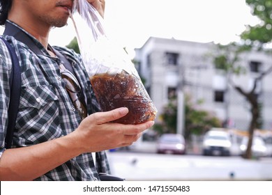 Men are drinking soft drinks packed in bags.