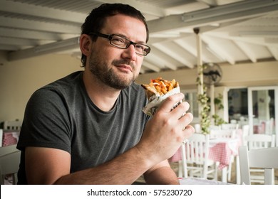 Men Eating Kebab - Meat With Vegetables In Pita Bread Roll.