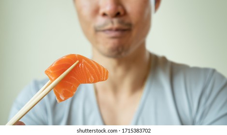 Men Eating A Sashimi Salmon.