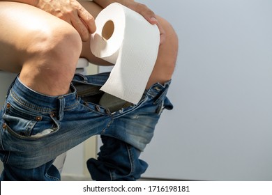 Men Entering The Toilet And Rectal Bleeding Concept, Symptom Of A Serious Disease Such As Colorectal Cancer, Hemorrhoids And Gastrointestinal Bleeding