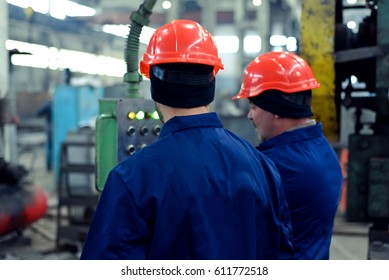 Men at the factory in helmets metallurgy - Shutterstock ID 611772518