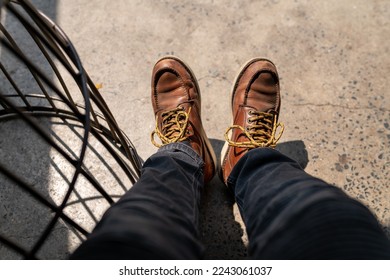 Men fashion in leather boots, Close up view on man's legs in black jeans and brown leather boots, Toned picture. - Powered by Shutterstock