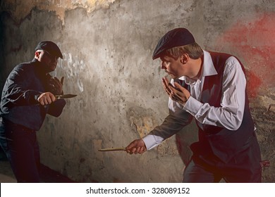 Men fighting with knives at urban street