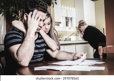 A Men With Financial Stress At Home Table With Teen Trying To Help