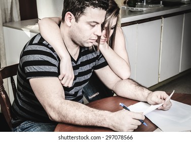 A Men With Financial Stress At Home Table With Teen Trying To Help