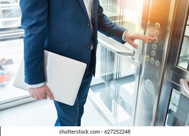 Men finger presses the elevator button. Businessman is a lift. high floor - Powered by Shutterstock