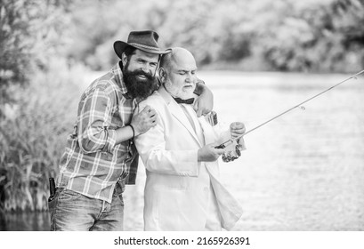 Men friends relaxing nature background. Personal instructor. Bearded man and elegant businessman fish together. Learn to fish. Fish with companion who can offer help in emergency. Fishing skills