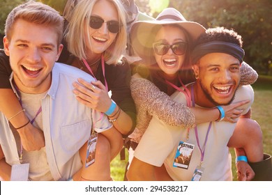 Men Giving Woman Piggybacks On Their Way To Music Festival