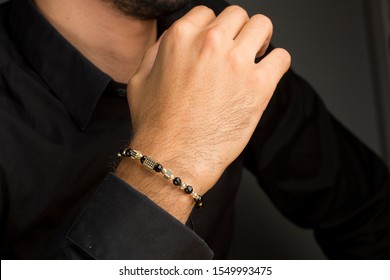 Men gold bracelet on hand