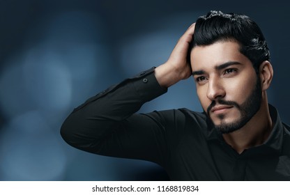 Men Hair Care. Handsome Man With Beard Touching Healthy Hair