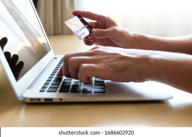 Men Hand Holding Credit Card And Type Payment Information On Keyboard For Order Online Shopping. Internet Technology And Digital Market Place E-Commerce Lifestyle Concept, Purchase Transaction.