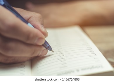 Men hand with pen are taking notes.