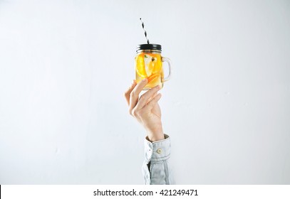 Men Hand Presents Homemade Cold Lemonade From Oranges, Sparkling Water And Ice Cubes Isolated On White. Refreshment Healthy Cold Drink In Summer Time