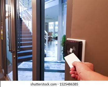 Men Hand Reaching To Use RFID Key Card To Access The Area. In Building Security Only For Authorized Person